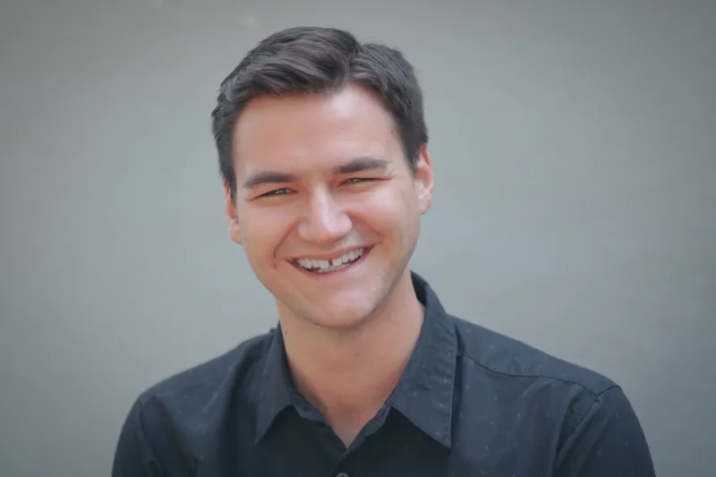 Brenden Davis a man wearing glasses and smiling at the camera