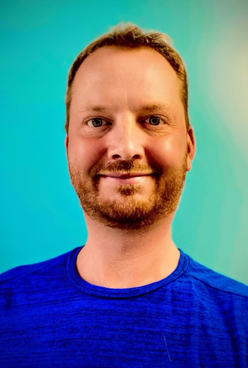 Joshua Greer a man wearing a blue shirt