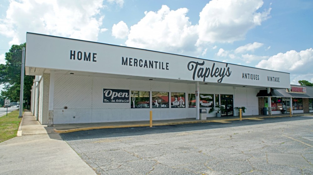 Storefront with signage: Home Mercantile Tapley's Antiques Vintage on a sunny day.