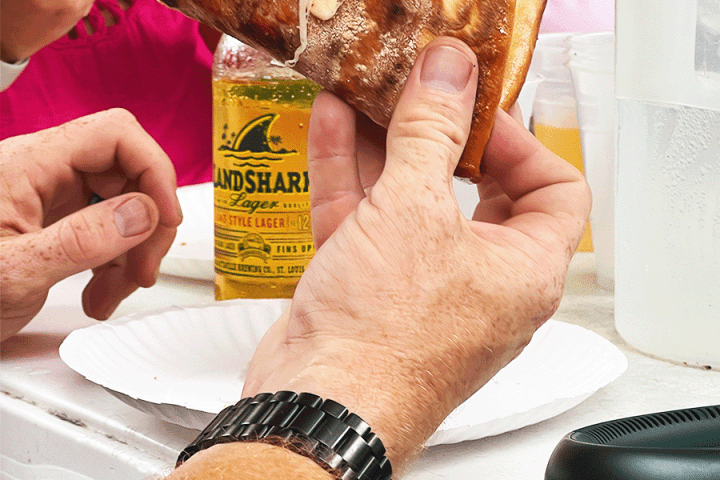 a person holding a piece of food