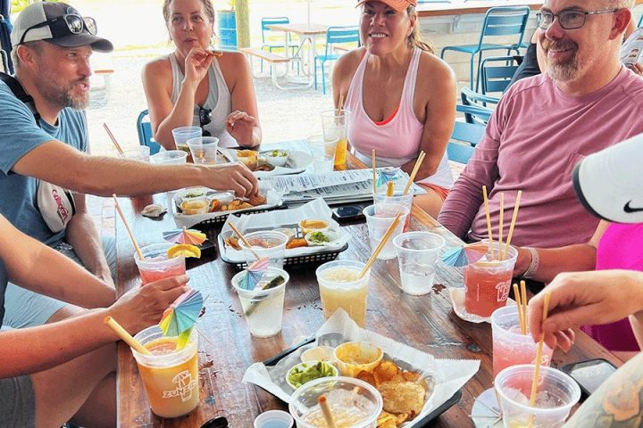 Gregor Habsburg et al. sitting at a table eating food