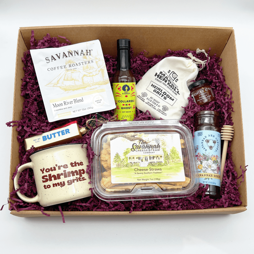 Gift box with coffee, cheese straws, honey, jam, grits, hot sauce, butter, and a mug.